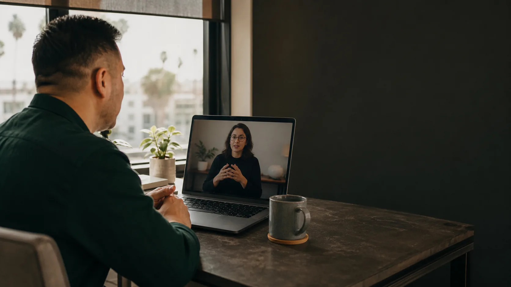 Deaf professional in a calm home office using a laptop for video remote interpreting